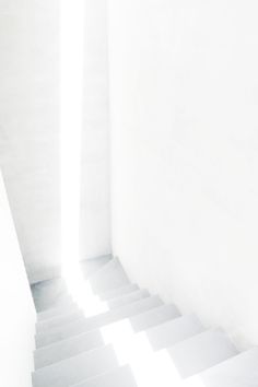 a cat sitting on top of a white stair case