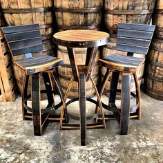 three wooden stools sitting next to each other in front of barrels