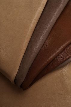 three different colors of leather on top of each other, one brown and one tan