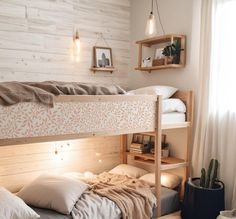 there is a bunk bed in the room with white walls and wood flooring on it