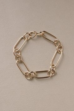 Bold yet timeless, our Roma Link Bracelet is the perfect piece for those who love a modern take on a classic look. Our completely handmade and soldered long and short links look stately resting at your wrist. Hand forged hook closure blends in seamlessly. The links of the Roma are completely formed & soldered in-studio in sterling silver or 14k gold. To finish the gold vermeil styles, we send our sterling Romas to Rhode Island where a 2nd generation family business heavy plates them in 100mi Classic Chain Bracelet With Solid Link Construction, Classic Metal Bracelet With Oval Link, Classic Metal Bracelets With Oval Link, Classic Link Bracelets With Solid Link Construction, Classic Jubilee Link Chain Bracelet, Classic Jubilee Chain Bracelet, Timeless Gold Bracelets With Rectangular Links, Classic Oval Link Chain Bracelets, Classic Polished Chain Link Bracelets