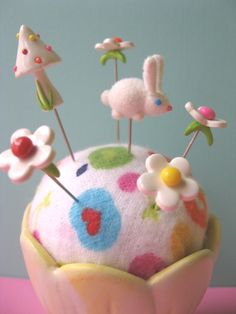 there is a cupcake decorated with pins and flowers