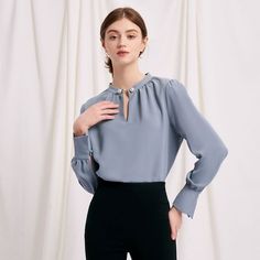 Everyone's favourite modern vintage Buvette Pearl blouse now updated in a pigeon-blue hue, featuring gently puffed sleeves, french cuffs and our signature pearl embellishment at the collar. Look office ready with our staple Emery pants and leather mules. Elegant Blue Blouse With Pleated Sleeves, Elegant Business Blouse For Fall, Elegant Blue Blouse With Puff Sleeves, Chic Blue Blouse With Button Cuffs, Elegant Blue Top With Button Cuffs, Blue Pleated Sleeve Tops For Work, Elegant Blue Tops With Button Cuffs, Elegant Puff Sleeve Blouse For Office, Blue Blouse With Blouson Sleeves For Work