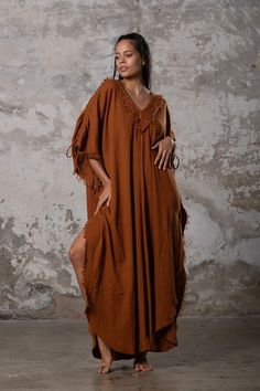 PUSKUL Kaftan embodies the essence of boho-chic, a natural and ethereal dress that effortlessly combines comfort and style. Crafted from the softest cotton available, this dress will envelop your skin like a gentle, warm embrace. PUSKUL Kaftan is versatile and can be worn on any occasion, from the dance floors to formal events, street wear to desert outfits. You can also wear it in two distinct styles: as a kaftan or as a sultry dress, simply by changing the way you put it on! Puskul Kaftan is e Bohemian Cotton Maxi Dress With Natural Dye, Elegant Cotton Beach Kaftan, Elegant Cotton Kaftan For The Beach, Bohemian Spring Beach Dress, Spring Bohemian Beach Dress For Loungewear, Bohemian Relaxed Fit Unlined Dress, Bohemian Natural Dye Maxi Dress For Summer, Bohemian Maxi Dress With Natural Dye For Summer, Bohemian Brown Linen Dress