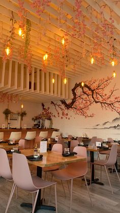 an empty restaurant with tables and chairs in front of a painting on the wall behind them