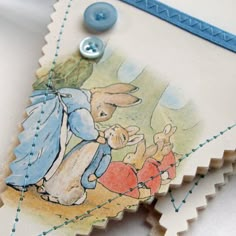 a close up of a card with an image of peter rabbit and the little red riding horse