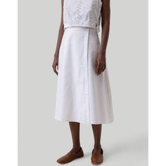 Elevate your wardrobe with our Reistor Overlap Midi Skirt! This elegant white midi skirt boasts a wrap-style design featuring chic button detailing along the side, adding a touch of classic sophistication to your look. Crafted for a regular fit with an elasticated back, this versatile skirt is ideal for a range of occasions, be it casual outings or formal events. Perfect for summer, this skirt effortlessly complements various tops and shirts, making it an essential addition to your women's summe Classic White Relaxed Maxi Skirt, Chic White Maxi Skirt For Work, White Maxi Skirt For Spring Workwear, Elegant White Skirt With Buttons, White Flared Maxi Skirt For Work, White Asymmetrical Wrap Skirt For Spring, White Feminine Skirt For Work, Elegant Relaxed Maxi Skirt With Button Closure, Chic White Wrap Skirt