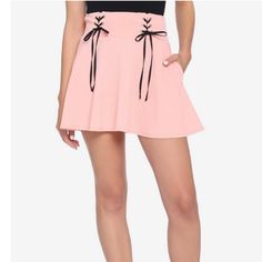 This Pastel Pink Skater Skirt Features Two Lace-Up Panels With Black Ribbon. Elasticated Waistband And Side Seam Hip Pockets. 97% Polyester; 3% Spandex Wash Cold; Dry Low Side Seam Hip Pockets Lace-Up Size M