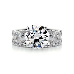 a diamond engagement ring and wedding band set with two rows of diamonds on each side