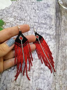 Elegant Red Tassel Earrings With Dangling Beads, Elegant Red Beaded Earrings For Festival, Red Long Drop Earrings With Dangling Beads, Red Tassel Earrings With Fringe And Round Beads, Red Fringe Tassel Earrings With Round Beads, Red Dangle Tassel Earrings With Fringe, Red Long Drop Beaded Earrings As Gift, Red Long Drop Beaded Earrings In Bohemian Style, Red Tassel Earrings With Round Beads As Gift