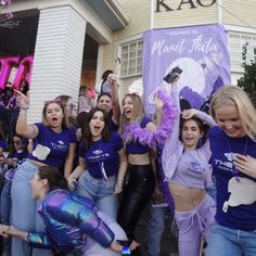 a group of young women in purple outfits