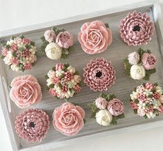 a tray filled with lots of pink and white flowers