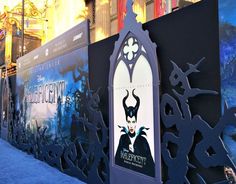 an image of a movie poster on the side of a building in front of it