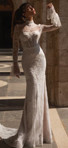 a woman in a wedding dress posing for the camera