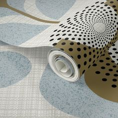 an artistic wallpaper with black and white polka dots on light blue ground covering it