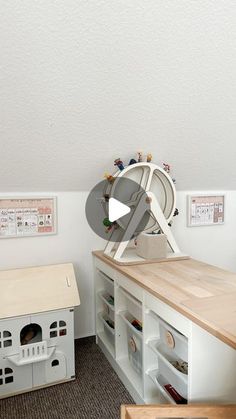 a room with a cat house, desk and shelves