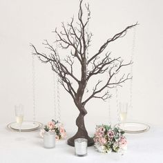 there is a tree that has been decorated with flowers and chains on the branches for decoration