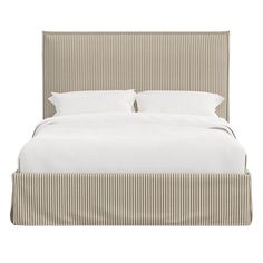 a bed with white sheets and pillows on top of it's headboard, in front of a white background