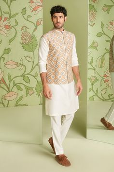 Ivory cotton silk embroidered bundi in applique and resham work. Paired with solid pant and kurta.
Component: 3
Pattern: Embroidered
Type Of Work: Applique work, Resham work
Neckline: Mandarin collar
Sleeve Type: Full sleeves
Fabric: Cotton silk
Color: White
Other Details: 
Embroidered placket kurta
Occasion: Reception - Aza Fashions Cotton Bandhgala With Zari Work And Long Sleeves, Cotton Long Sleeve Bandhgala With Zari Work, Wedding Cotton Bandhgala With Gota Work, Designer Cotton Bandhgala With Long Sleeves, Cotton Bandhgala With Resham Embroidery Long Sleeve, Festive Cotton Bandhgala With Naqshi Details, Festive Cotton Bandhgala With Naqshi, Designer Cotton Sets With Chikankari Embroidery, Designer Cotton Fitted Nehru Jacket