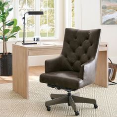 a brown office chair sitting in front of a desk with a potted plant on it