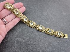 "A stunning vintage yellow Czech glass bracelet in gold tone filigree metal. This is a lovely, ornate example. It has a hidden clasp for a continuous look. I purchased this piece at an antiques shop in Budapest, Hungary. No marks. Measures about 7\" long and .625\" at the widest. Please note, this is offered AS IS, the push button on the clasp has been broken off. The clasp still works, but you have to use your fingernail to open it. Some tarnish and wear to the metal finish. Actual packaging wi Native American Traditions, Baccarat Crystal, Glass Bracelet, Budapest Hungary, Gold Filigree, Antique Shops, Vintage Yellow, Push Button, Chain Link Bracelet