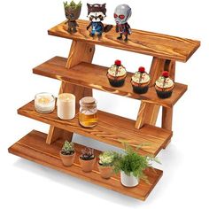 three tiered wooden shelf with cupcakes and candles