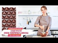 a woman is making food in the kitchen with chocolates on the wall behind her