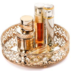 a gold tray with perfume bottles on it