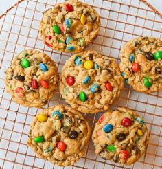 cookies with m & m's and chocolate chips are on a cooling wire rack