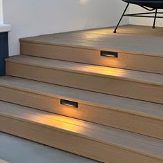 some steps with lights on them and a chair in the background