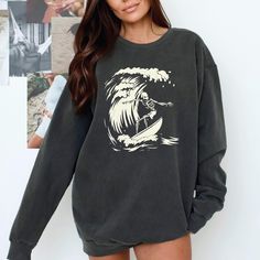 Surfer Ghoul Sweatshirt - Ride the Waves of Style This Halloween and Beyond! 🌊 Are you ready to catch some serious style this season? Dive into the spirit of Halloween with our Surfer Ghoul Sweatshirt, where the laid-back vibes of surfing meet the playful spookiness of the season! This isn't just any sweatshirt; it's your new go-to piece that combines comfort, uniqueness, and a whole lot of character. 🧵 Product Features: Premium Fabric: Made from 80% ring-spun cotton and 20% polyester, our swe Oversized Band Merch Long Sleeve Sweatshirt, Oversized Long Sleeve Band Merch Sweatshirt, Black Crew Neck Soft-washed Sweatshirt, Black Soft-washed Crew Neck Sweatshirt, Grunge Style Sweatshirt With Screen Print And Relaxed Fit, Grunge Crew Sweatshirt For Winter, Grunge Crew Neck Sweater For Halloween, Grunge Crew Neck Sweatshirt For Winter, Grunge Long Sleeve Sweatshirt For Fall