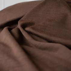 Merino Wool Jersey knit in a gorgeous chocolate brown.   This fabric has a soft hand and is light and flowy, perfect for a top or cardigan. It makes a perfect layering piece. A generous width at 63 inches and a mechanical stretch.  Close up image. Brown Merino Wool Tops For Fall, Brown Merino Wool Top For Fall, Brown Stretch Soft Knit Top, Brown Merino Wool Top For Layering, Fancy Frocks, Jersey Knit Fabric, Soft Hands, Soft Hand, Layering Pieces