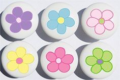 six flower buttons in different colors on a white background