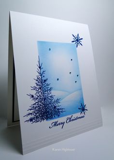 a christmas card with snowflakes on it and a tree in the middle,