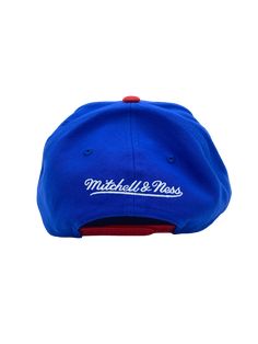 Clean and classic look with the Mitchell & Ness feel to it. You want to be sure everyone knows that you will always support your team. You can do just that by putting on this Classic 2 Tone snapback hat from Mitchell & Ness. It features bold graphics embroidered on the crown, perfect for showcasing your style. High Crown Structured fit Adjustable hat One size fits all Flat bill Snapback Six panels with eyelets Raised embroidery One size fits most Officially licensed Imported Brand: Mitchell & Ne Blue Baseball Cap For College During Baseball Season, Throwback Blue Baseball Season Hats, Blue Throwback Snapback Baseball Cap, Blue Flat Bill Snapback Hat For Game Day, Blue Throwback Hat With Curved Brim, Throwback Blue Hat With Curved Brim, Blue Baseball Fan Merchandise Hats, College Blue Baseball Cap With Flat Bill, Blue Fan Merchandise Hats For Baseball Season