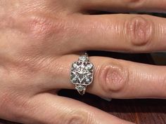 "The item is a sterling silver filigree diamond ring. The ring weighs 2.6 grams and is a finger size 7. The top part of the ring measures 11 millimeters wide and the bottom part of the ring measures 2 millimeters wide. The seven diamonds weigh .05 carats. The diamonds are a \"G\" color and \"SI2\" clarity. I can adjust the size on it . I will provide a ring box with the ring." Elegant Sterling Silver Diamond Ring With Rose Cut, Intricate Design Round Cut Diamond Ring Gift, Gift Round Cut Diamond Ring With Intricate Design, Heirloom Silver Jewelry With Rose Cut Diamonds, Silver Jewelry With Intricate Design In Platinum, Round Cut Diamond Ring With Intricate Design, Heirloom Silver Filigree Ring With Intricate Design, Classic Silver Engraved Ring With Diamond Accents, Art Deco Sterling Silver Jewelry With Single Cut Diamonds