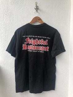 PLEASE ASK ANY QUESTION BEFORE BUYING!!! THIS IS USED CLOTHING!!! PLEASE DONT EXPECTED IT TO BE LIKE NEW OR IN PRISTINE CONDITION!!!PLEASE REFER TO THE ACTUAL/MANUAL SIZE TAKEN!!!Size  : LCondition : 8/10Made : USA by HanesColor :  Black / Promo Band teeMeasurement :armpit to armpit= 21.5"inchesLenght from top of the shoulder to bottom= 27"InchesIn a good vintage condition Vintage but still good and niceNo tears No Hole And Good but got glue stain(refer last photo)SHIPPING (Your Choice Please re Heavy Metal Bands, Metal Band, Metal Bands, Used Clothing, Band Tees, Heavy Metal, Black Shirt, Glue, Graphic Tees