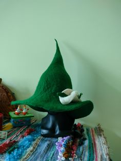 I made this hat from green sheep wool using the felting method. A voluminous flower is included with the hat  and a hand-woven wool belt. With its help you can adjust the diameter of the hat and decorate it.   Brim diameter 39 cm. Hat With Feather, Witch Hat Halloween, Wizard Hat, Hat Fedora, Historical Reenactment, Costume Hats, Felted Wool, Brim Hat, Fedora Hat