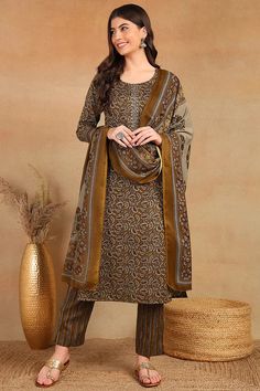 Grab this beautiful 3-piece set. The set comes with ethnic motif print detailing straight shape kurta has round neck, 3/4th sleeves & calf length teamed with printed trouser pant with single pocket and a printed dupatta. Color - Brown Kurta Fabric-Cotton Blend Pant Fabric-Cotton Blend Dupatta Fabric - Cotton Blend Neck-Round Neck Sleeves-3/4th Sleeves Work - Ethnic Motif Print Detailing Washing Instructions-Dry Clean Model Height - 5.5 wearing size small. DISCLAIMER - The color of the product ma Festive Straight Kurta Set With Printed Border, Navratri Sets With Printed Border And Straight Kurta, Printed Straight Kurta Set For Eid, Unstitched Printed Sets For Navratri, Traditional Printed Sets With Straight Kurta, Straight Kurta Set With Printed Border For Diwali, Eid Straight Kurta Palazzo Set Printed, Eid Festival Printed Palazzo Set With Straight Kurta, Diwali Straight Kurta Set With Printed Border