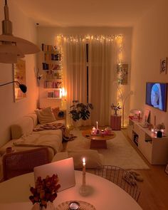 a living room filled with furniture and a flat screen tv on top of a wooden table