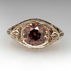 This elegant vintage ring is centered with one (1), bead set, old European cut diamond weighing 1.25 carats. The side faces of the ring feature a pierced design. The ring measures 8.7mm at the top, rises 5.5mm above the finger, tapering to 1.5mm wide and 1.1mm thick at the base of the shank. This ring is currently a size 3. Classic Collectible Diamond Ring With Center Stone, Classic Collectible Rings With Diamond Cut, Antique Yellow Gold Diamond Ring With Bezel Setting, Vintage Brilliant Cut Diamond Ring, Art Deco Topaz Ring With Diamond Center Stone, Vintage Diamond Ring With Brilliant Cut, Vintage Brilliant Cut Round Diamond Ring, Vintage Diamond Ring With Center Round Stone, Vintage Diamond Ring With Brilliant Round Cut