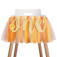 an orange and yellow birthday chair cover with the word one on it