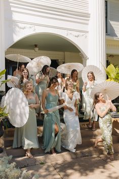 a group of women holding umbrellas standing next to each other in front of a building