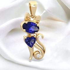 Elegant golden curves, sparkling gems, and a brilliant diamond merge to form a demure lab sapphire and lab sapphire kitten pendant in 14K Gold. Select any two gemstones to create a unique keepsake symbolizing your connection to your beloved pet. Chain not included. Gem: Lab Created Sapphire Metal: solid 14K Gold Diamonds: genuine SI2 diamonds Free gift packaging is included with every order. Yellow Gold Lab-created Sapphire Jewelry Gift, Fine Jewelry Gold Ring With Lab-created Sapphire, Gold Jewelry With Lab-created Sapphire For Anniversary, Gold Jewelry With Lab-created Sapphire Birthstone, Gold Birthstone Jewelry With Lab-created Sapphire, Diamond Free, Brilliant Diamond, Gift Packaging, Free Gift