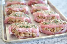 some food is laying out on a baking sheet with sprinkles and seasoning