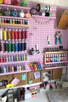 the craft room is organized with pegs, scissors, and other crafting supplies