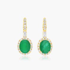 14K Yellow Gold Halo Emerald and Diamond Petite Drop Earrings. These earrings are fit for a queen. The brilliant green emeralds are surrounded by sparkling diamonds in a perfect halo setting. These drop earrings are set in yellow gold to give a look that is as stylish as it is regal. Green Emerald Diamond Earrings With Accents, Emerald Green Diamond Earrings With Accents, Green Pave Setting Earrings For Wedding, Green Oval Diamond Earrings, Classic Green Diamond Earrings With Halo Design, Green Diamond Earrings With Halo Setting, Green Diamond Earrings With Halo Design, Classic Green Diamond Earrings With Halo Setting, Jewelry Photoshoot