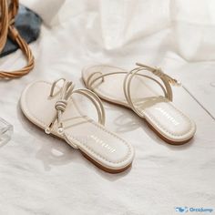 OrcaJump - Stylish and Breathable Flat Sandals for the Summer Season Cream Toe Post Sandals In Synthetic Material, Cream Toe Post Synthetic Sandals, Beige Toe Post Sandals In Synthetic Material, Beige Toe Post Synthetic Sandals, Cream Toe Post Sandals For Beach, Adjustable Cream Synthetic Sandals, Cream Single Toe Strap Sandals For Beach, Woman Sandals, Summer Toes