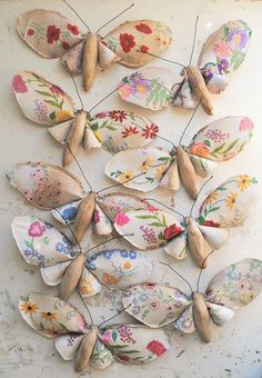 a bunch of spoons that are sitting on a table with flowers painted on them