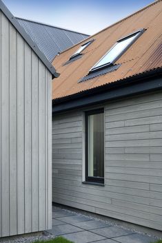 two windows on the side of a house